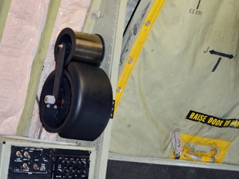 AMCE negator spring assembly installed on a C-130 paratroop door