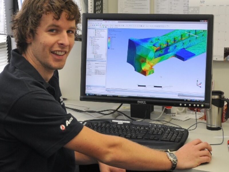 AMCE engineer reviewing a finite element analysis model at a workstation